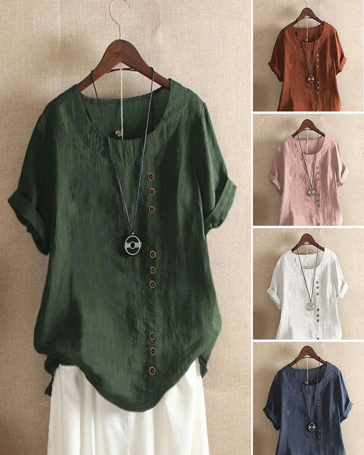 Woman wearing a stylish short sleeve button-front top, perfect for a relaxed spring look.