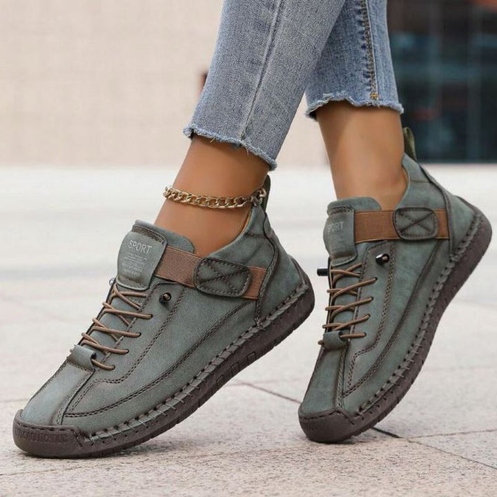Stylish women's low-top lace-up sneakers with unique stitching, perfect casual footwear for versatile fashion.