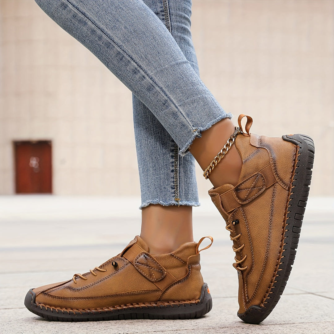 Fashionable women's footwear: stitched lace-up casual sneakers. Versatile low-top design for daily comfort.