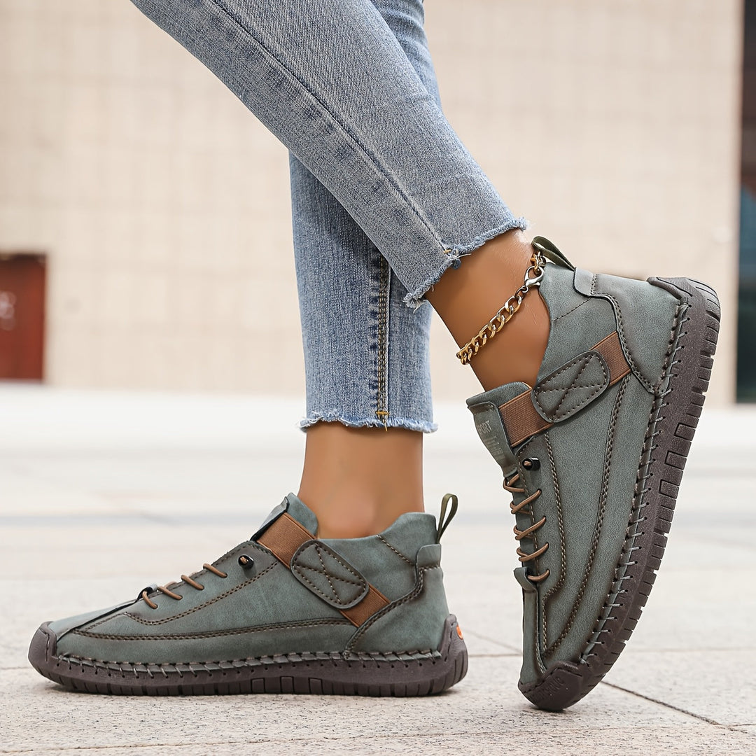 Comfortable & fashionable women's lace-up sneakers, stitched low-top design for versatile everyday wear.