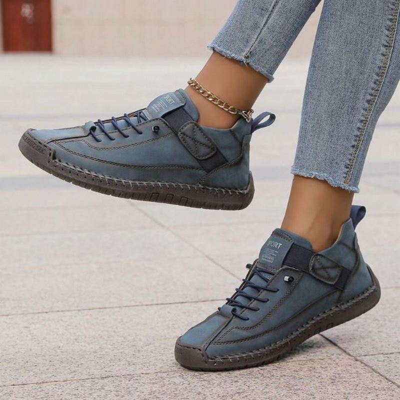 Women's casual low-top lace-up sneakers, featuring intricate stitching for a stylish and comfortable daily look.