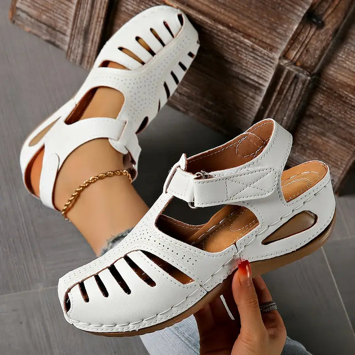 Stylish women's open-toe sandals; comfortable casual flats for everyday summer fashion. Modern and versatile footwear.