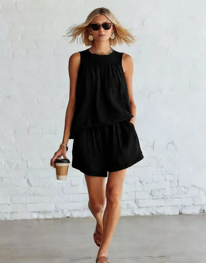 Chic women's two-piece set featuring a gathered sleeveless top & high-waist shorts, perfect for summer fashion.