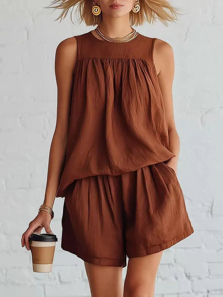 Relaxed fit women's casual outfit: sleeveless gathered top & high-waist shorts two-piece set for summer style.