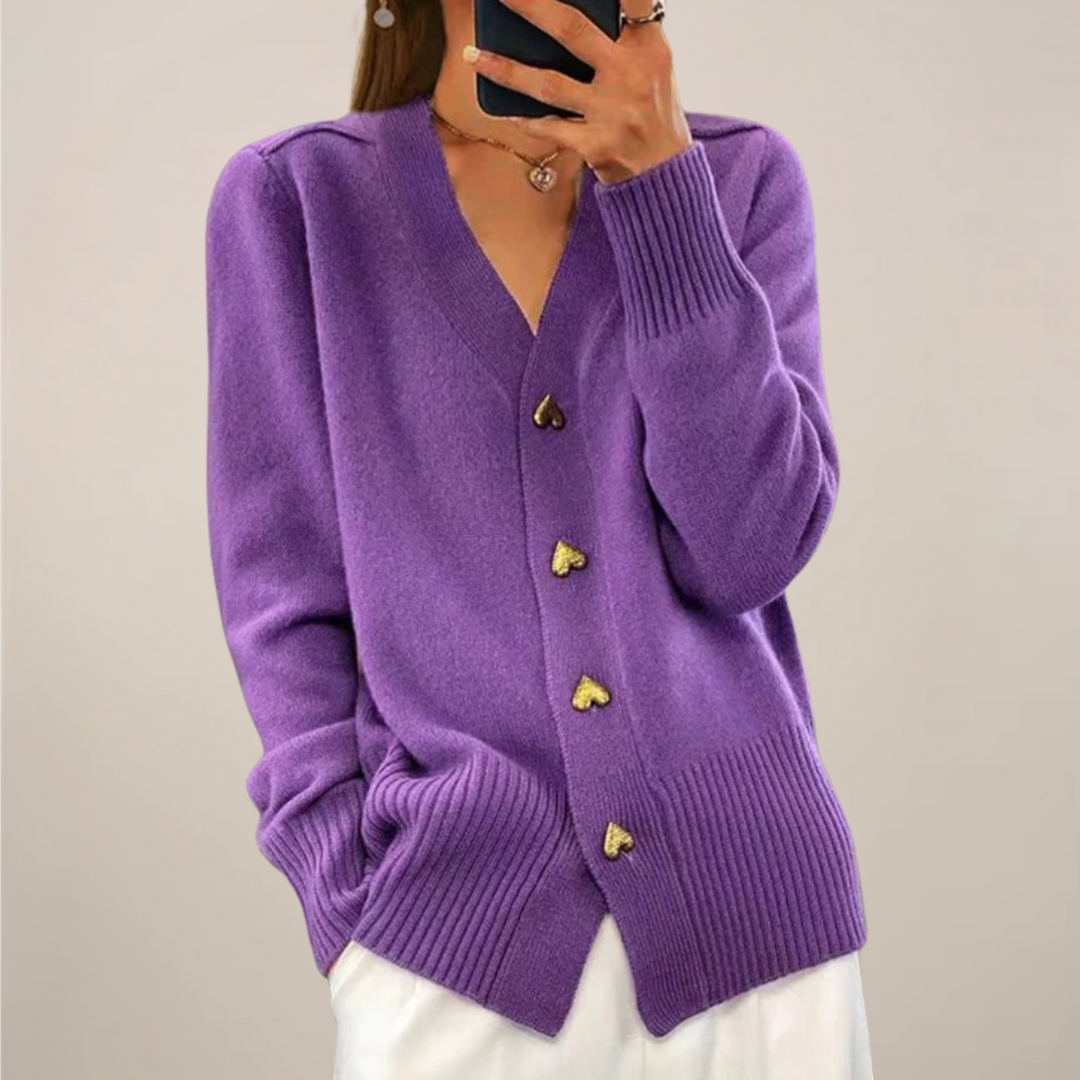Fashionable women's cardigan featuring unique gold heart buttons. Long sleeve, elegant, ideal for layering.
