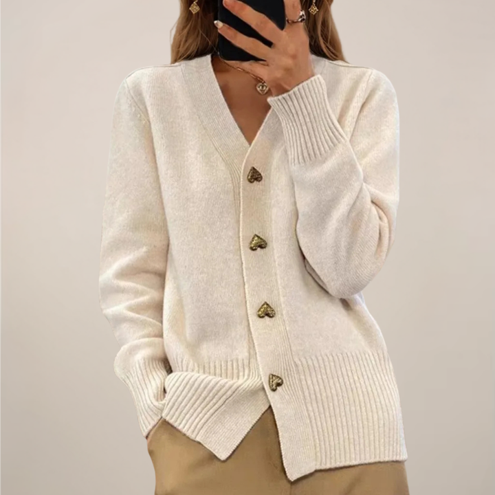 Classic women's long sleeve cardigan sweater with elegant gold heart buttons. A chic and comfortable layering piece.