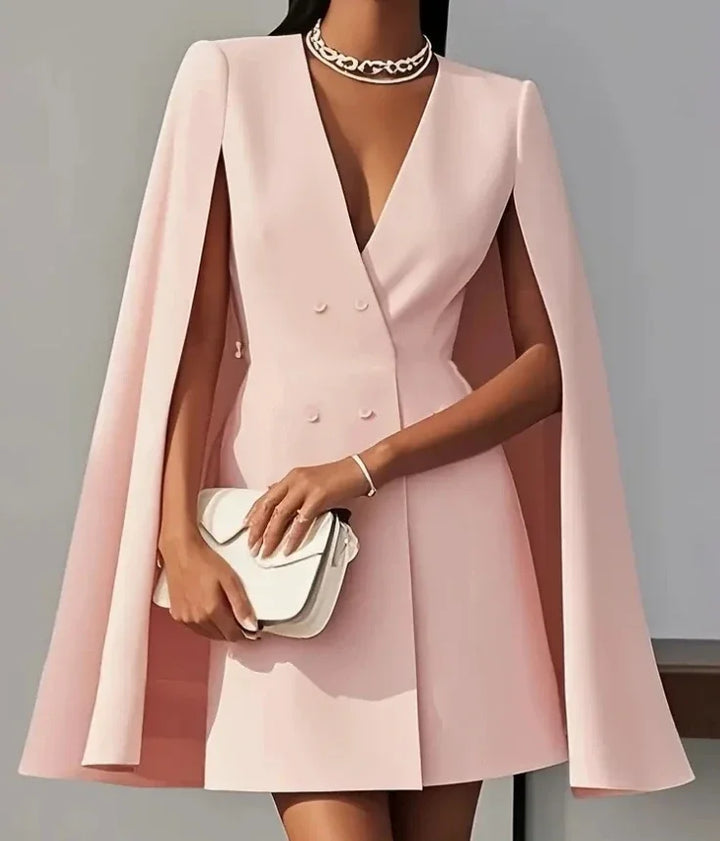 Modern women's fashion: chic double-breasted V-neck mini dress with stylish cape sleeves for a sophisticated look.
