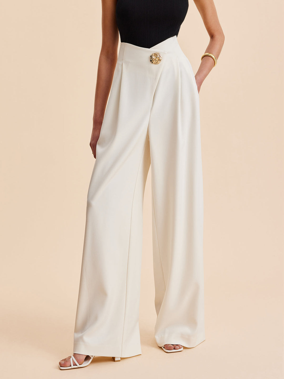 Women's chic embellished high-waist wide-leg pants. Elegant asymmetrical design for fashion bottoms.