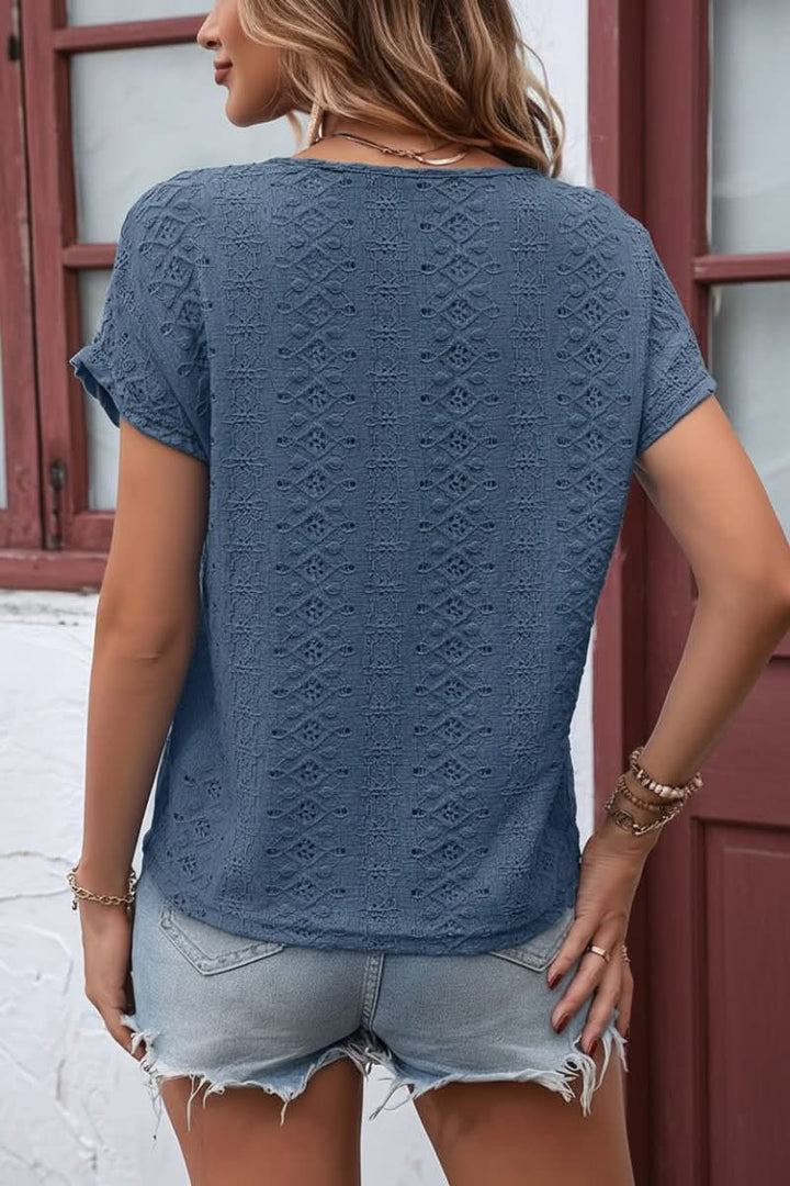 Comfortable women's eyelet top, short sleeve with notched neck. Versatile chic style for daily wear.