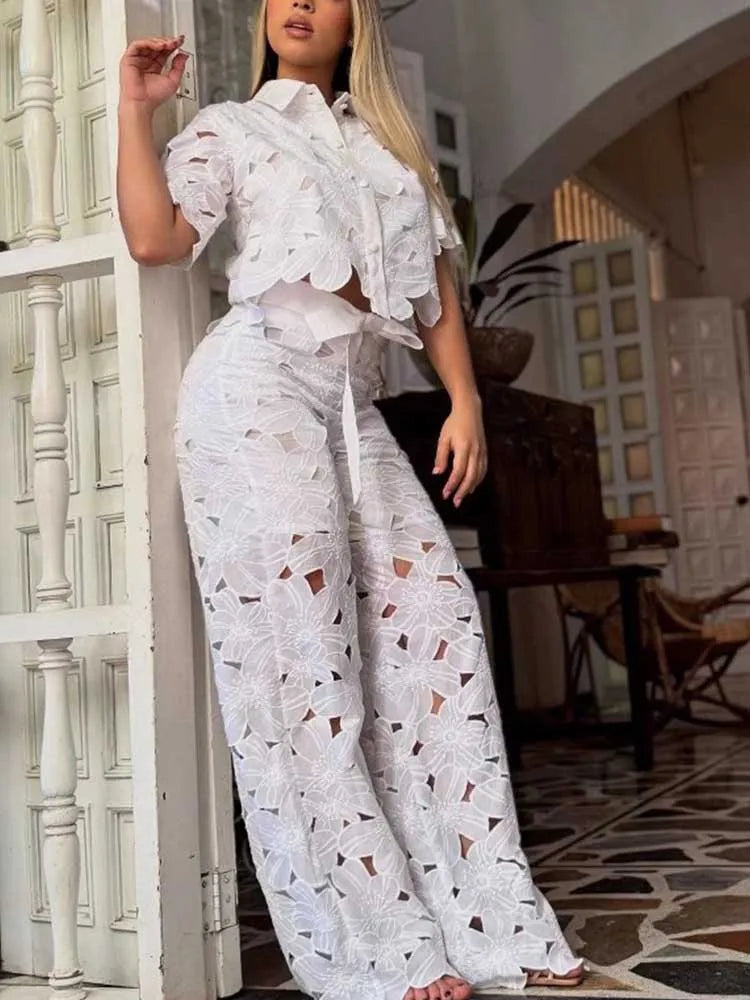 Women's chic floral two-piece set: cropped top & wide-leg pants. Elegant summer outfit.