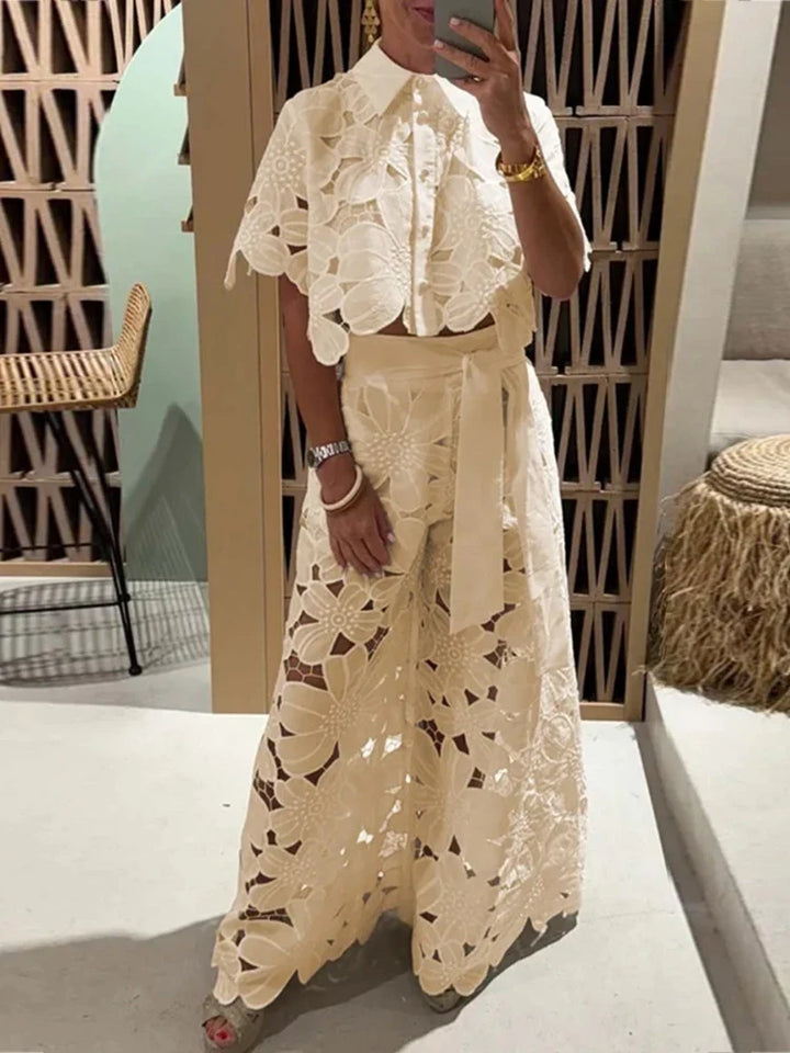Beautiful floral print two-piece resort wear set featuring a trendy cropped top & flowing wide-leg pants.