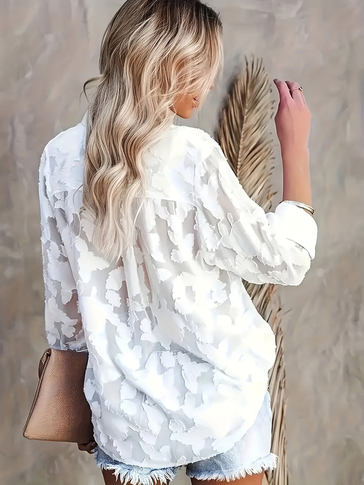Elegant women's V-neck blouse featuring a delicate jacquard texture, a sophisticated choice for any occasion.