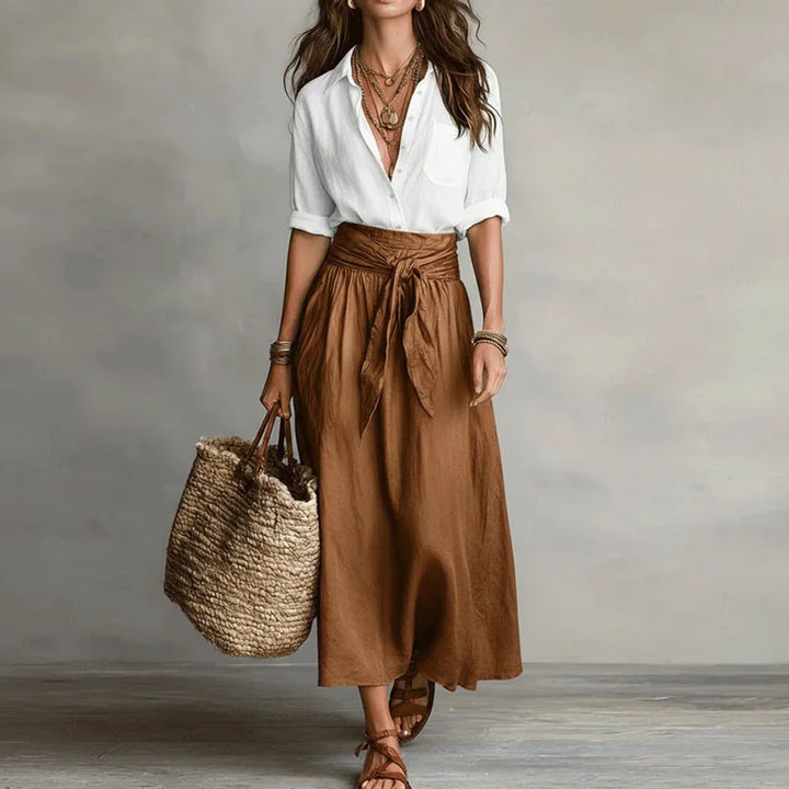Stylish women's two-piece skirt suit featuring a long sleeve top & a tie-waist skirt, ideal for casual outfits.