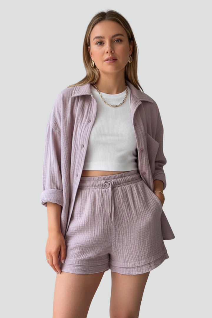 Trendy women's two-piece set featuring a button-up shirt and matching drawstring shorts. Chic and comfortable casual wear.