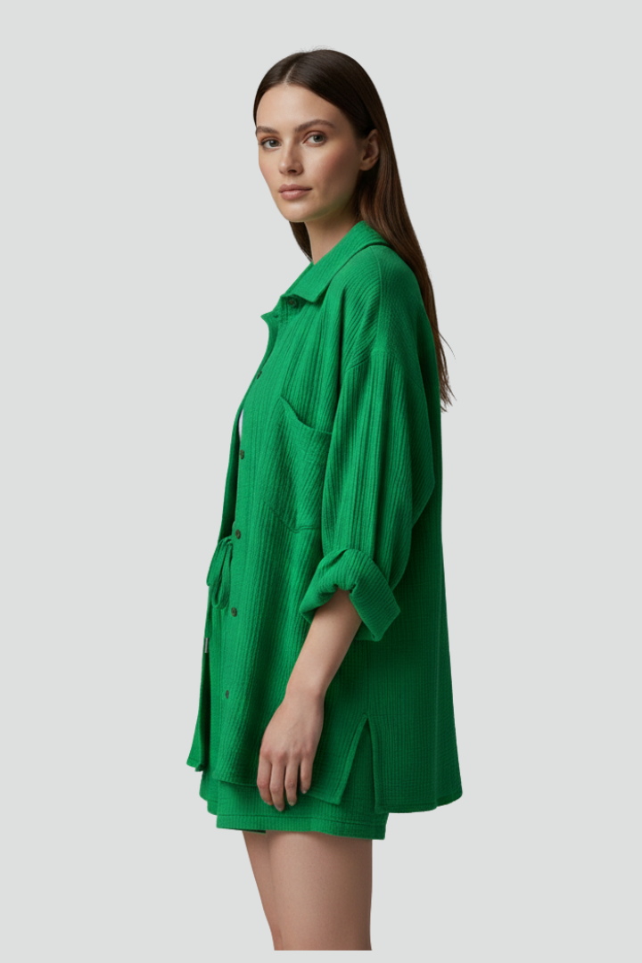 Comfortable women's lounge set with a stylish button-up shirt and elastic drawstring shorts. Perfect for relaxation.