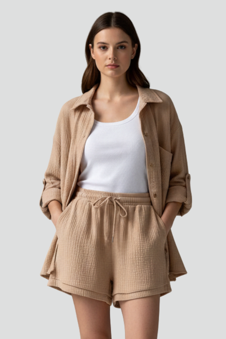 Relaxed fit women's two-piece set: elegant button-up top and soft drawstring shorts. Great for casual lounging.