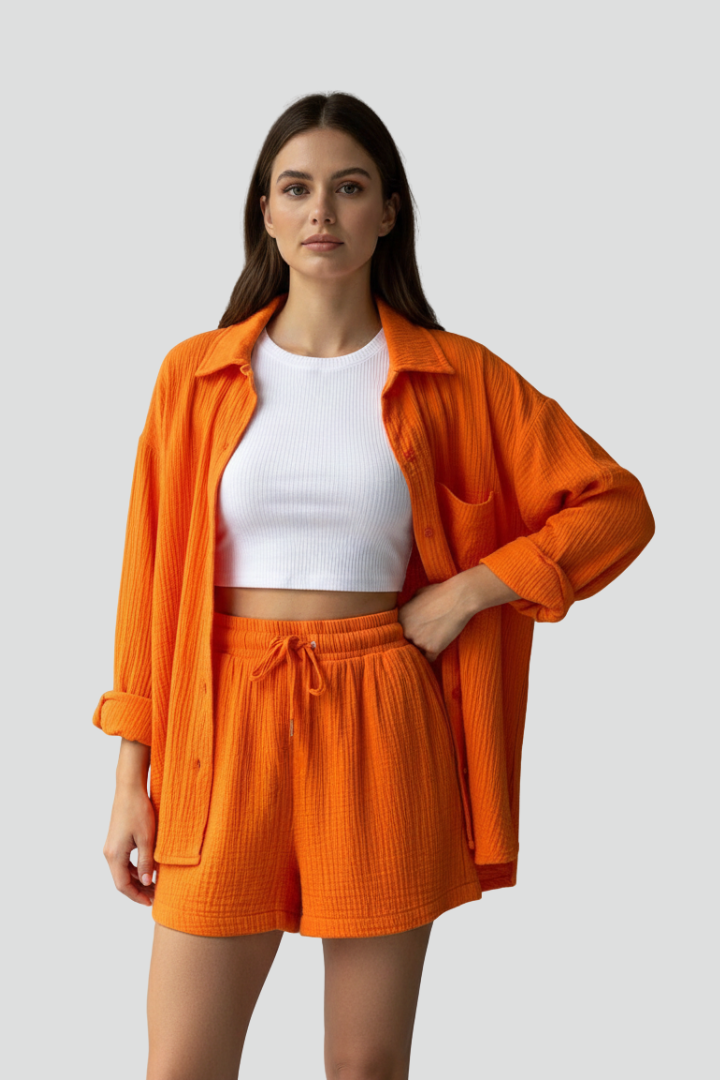 Modern women's chic lounge wear, including a long-sleeve button-up shirt and comfy drawstring shorts for everyday style.