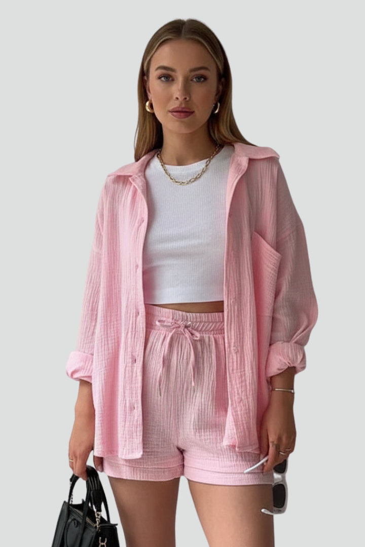 Elegant women's lounge outfit: a relaxed button-up shirt paired with comfortable drawstring shorts for home or errands.