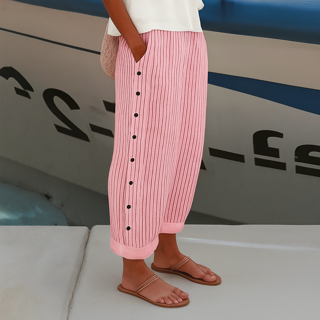 Stylish women's black and white cropped trousers with a chic stripe panel and button details, versatile fashion.
