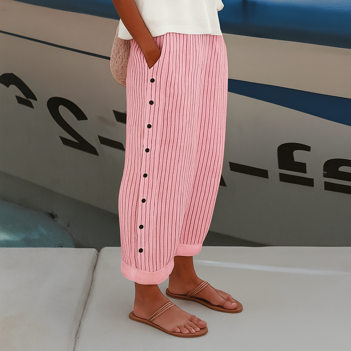 Stylish women's black and white cropped trousers with a chic stripe panel and button details, versatile fashion.
