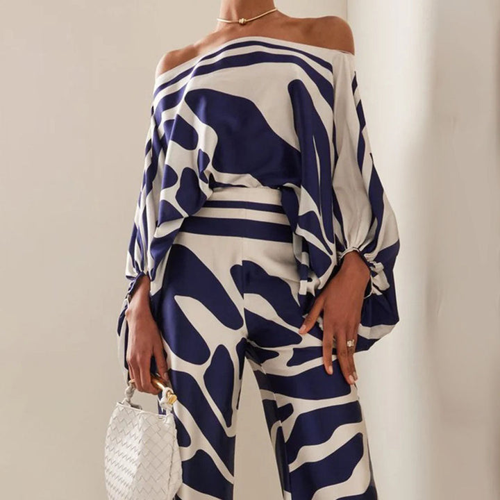 Woman wearing a stylish printed off-shoulder two-piece summer set, perfect for a chic vacation look.