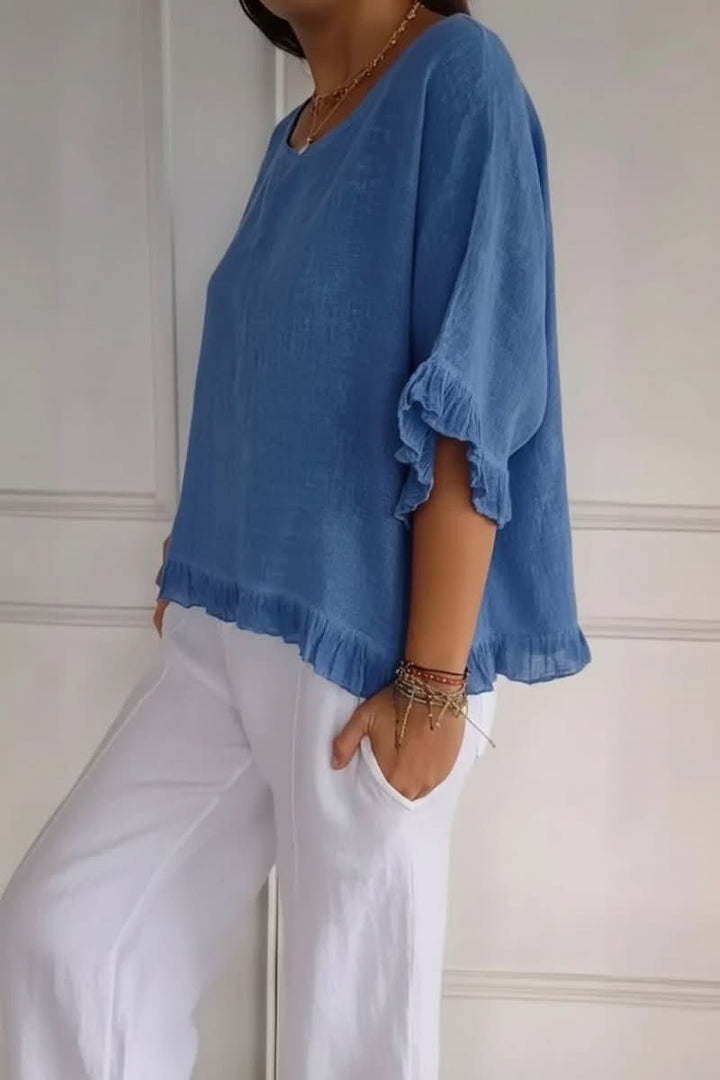 Elegant women's ruffle blouse, ideal for office or dressy occasions. Feminine fashion top.
