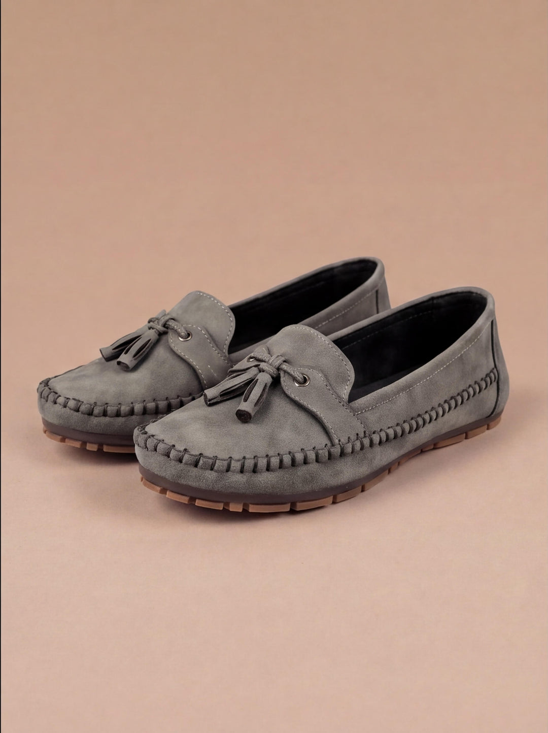 Stylish women's tassel moccasin loafers on foot, offering comfort and timeless elegance for any outfit.