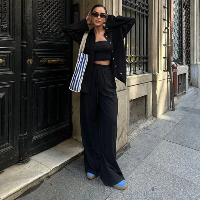 Modern women's two-piece outfit. Chic matching set with a relaxed button-down top & trendy wide-leg pants for comfort.