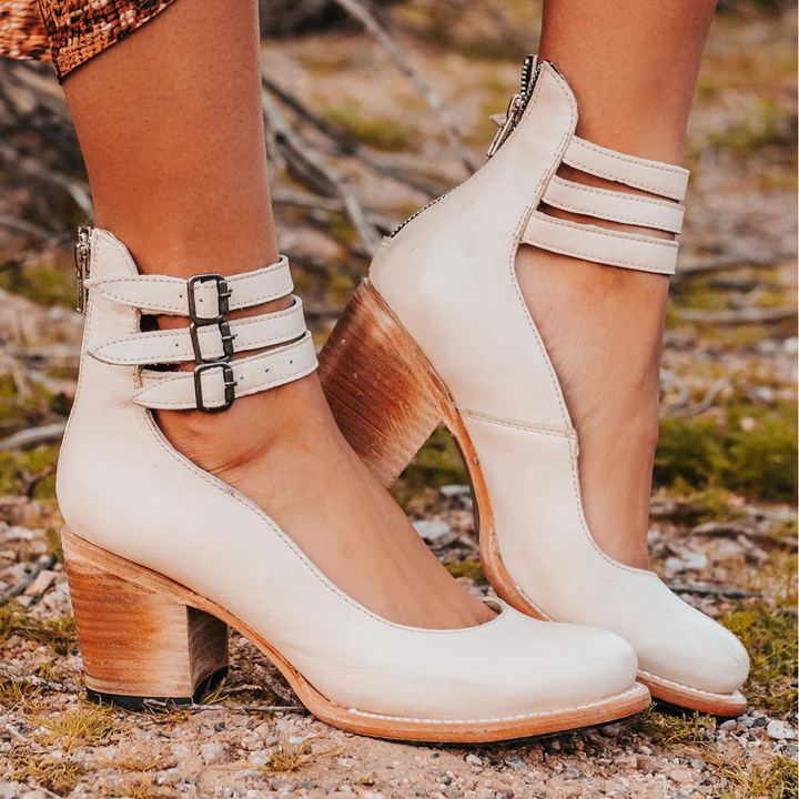 Versatile women's block heel pumps with an ankle strap and round toe. Great for work or special occasions.