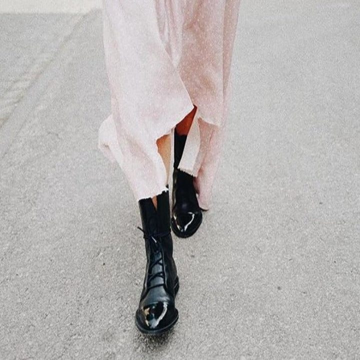 Classic black combat boots for women, featuring a lace-up design and durable construction for everyday wear.