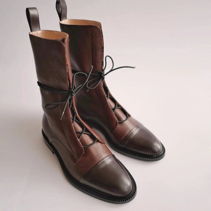 Fashionable women's black lace-up boots, combat style, offering comfort and trend for winter footwear.