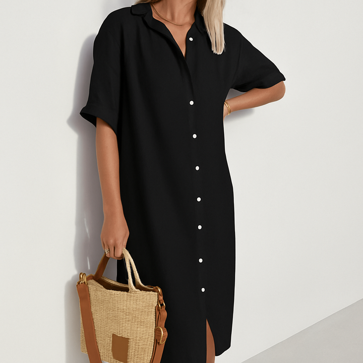 Comfortable women's button-down midi shirt dress with collar & short sleeves. Relaxed fit for versatile everyday wear.