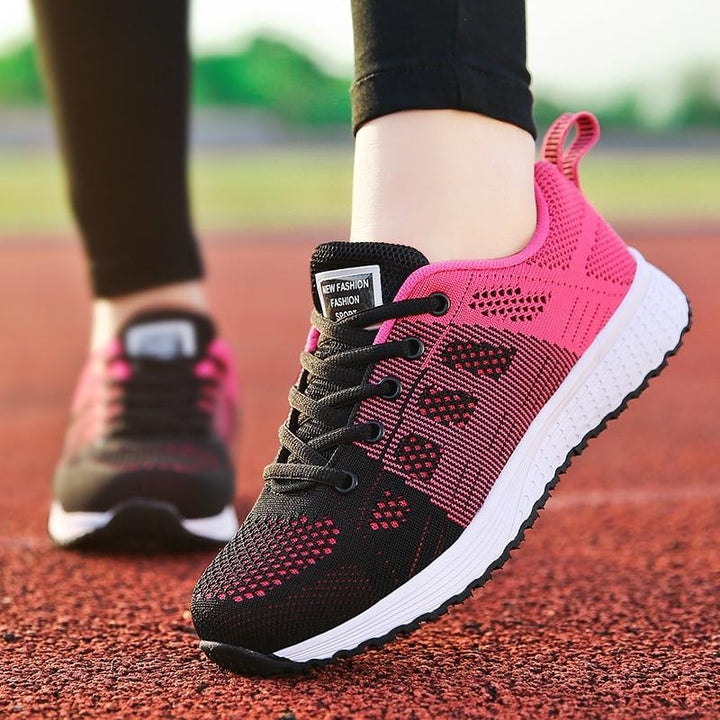 Top-down view of lace-up orthopedic shoes for women, white, designed for comfortable walking.