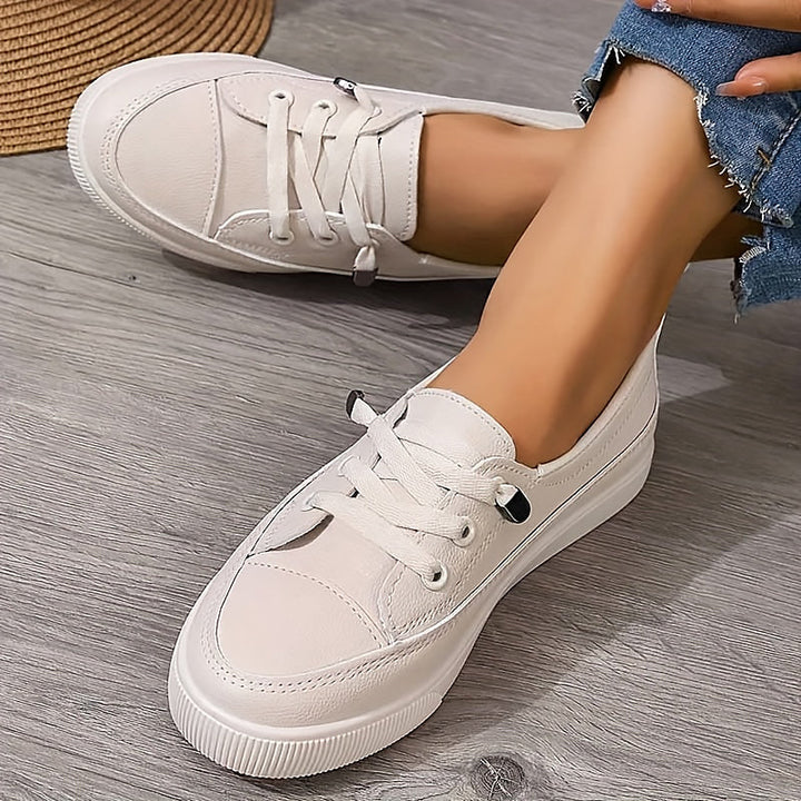 Women's classic white lace-up flatform court sneakers, perfect for casual everyday wear.