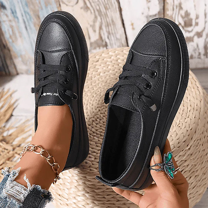 Comfortable women's flatform court sneakers with crisp white design and classic lace-up detailing.