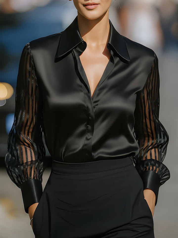 Women's collared button-up blouse with elegant sheer long sleeves, perfect for professional or business casual wear.