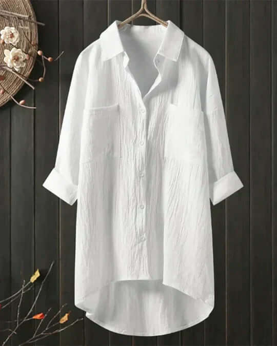 Women's collared longline blouse with double pockets & roll-tab sleeves. Casual button-down top, perfect for summer.