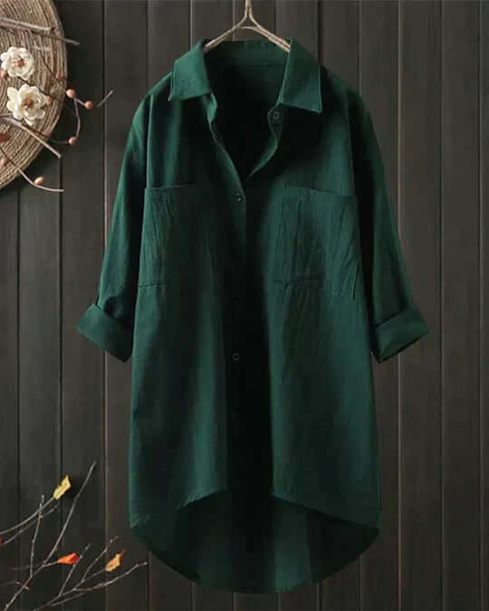 Easy-care women's travel blouse: collared, longline, with roll-tab sleeves & double pockets. Versatile summer top.
