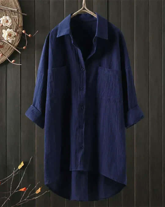 Women's button-down longline blouse. Collared top with double chest pockets & adjustable roll-tab sleeves. Casual wear.