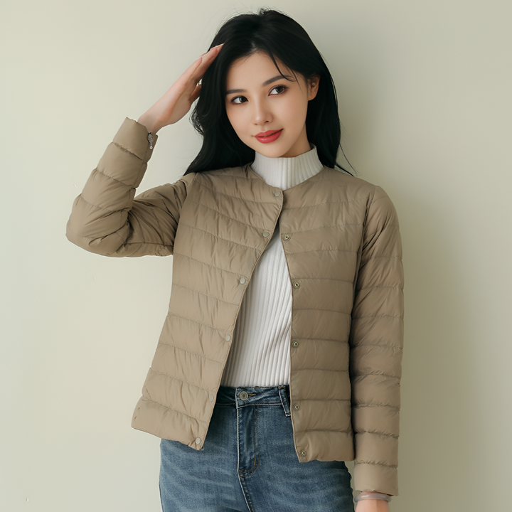 Women's collarless ultralight puffer jacket in black, perfect for layering comfort and minimalist style.