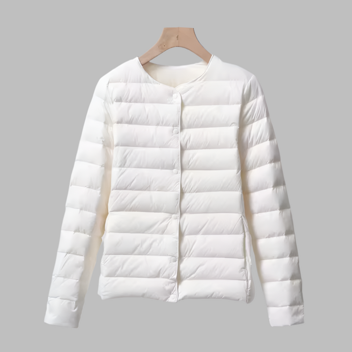 Packable women's ultralight puffer jacket, collarless design in navy, ideal for travel and spring outerwear.