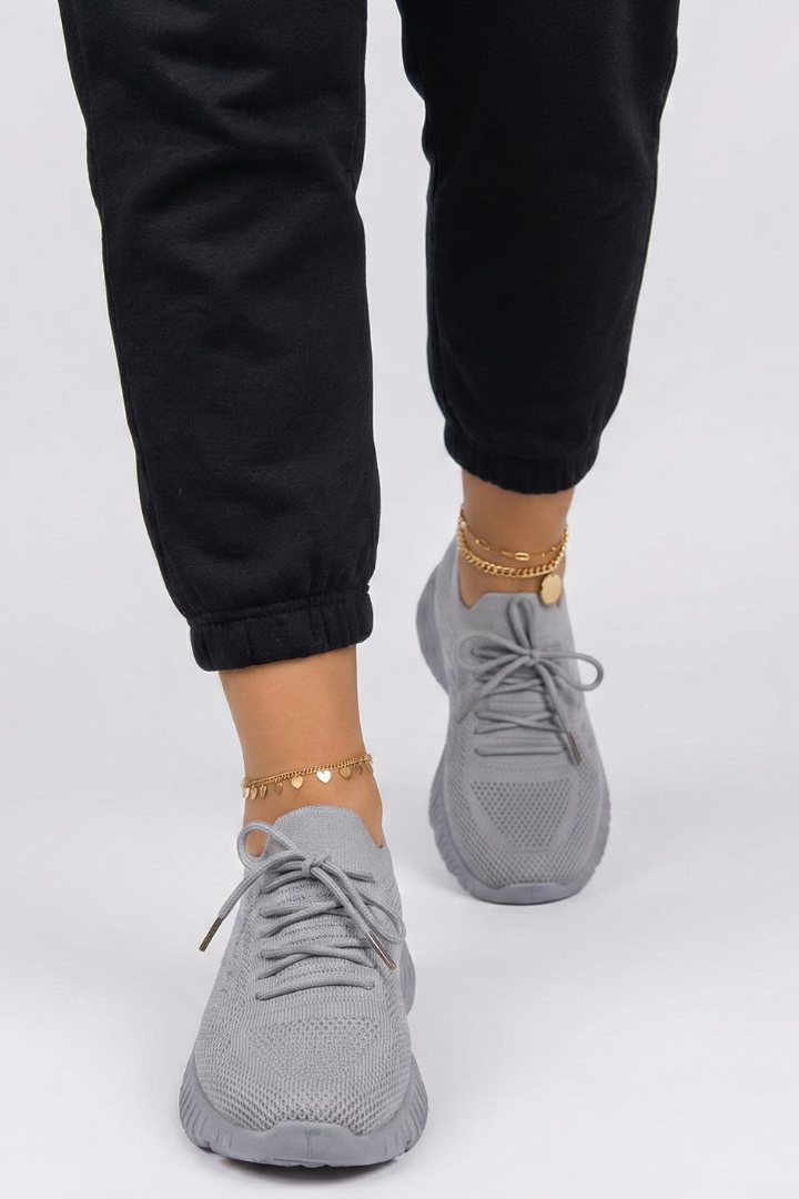 Lightweight women's knit sneakers with secure laces & a textured grip sole, ensuring comfort & stability.