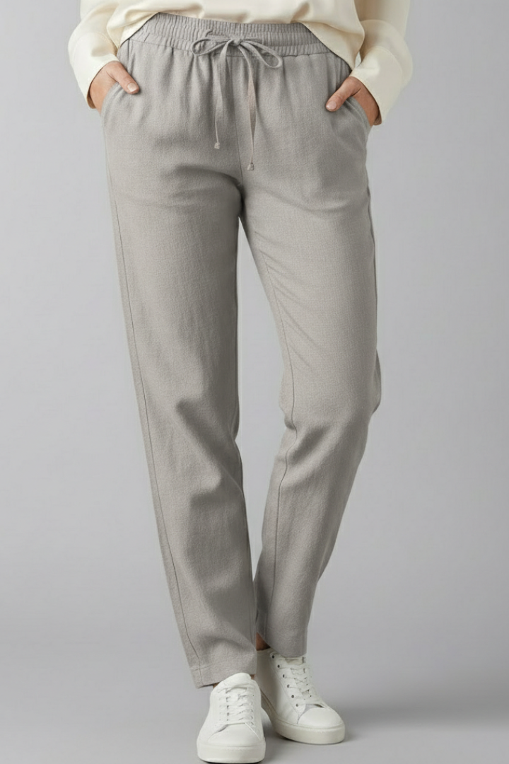 Woman modeling comfortable women's trousers with elastic waist & side pockets, relaxed fit.