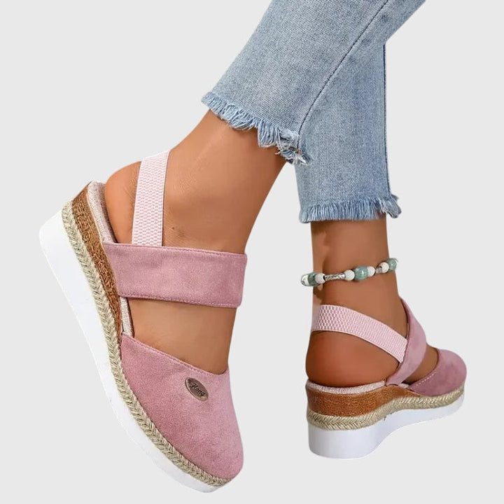 Flat women's sandals featuring intricate beading & a comfortable elastic ankle strap, bohemian style.