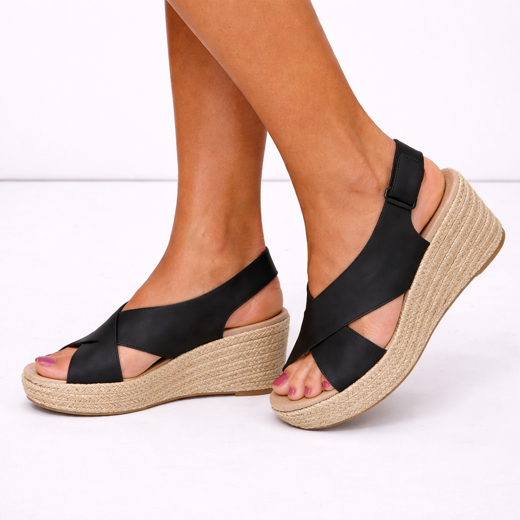Women's black crossover strap wedge sandals, stylish and comfortable for warm weather.