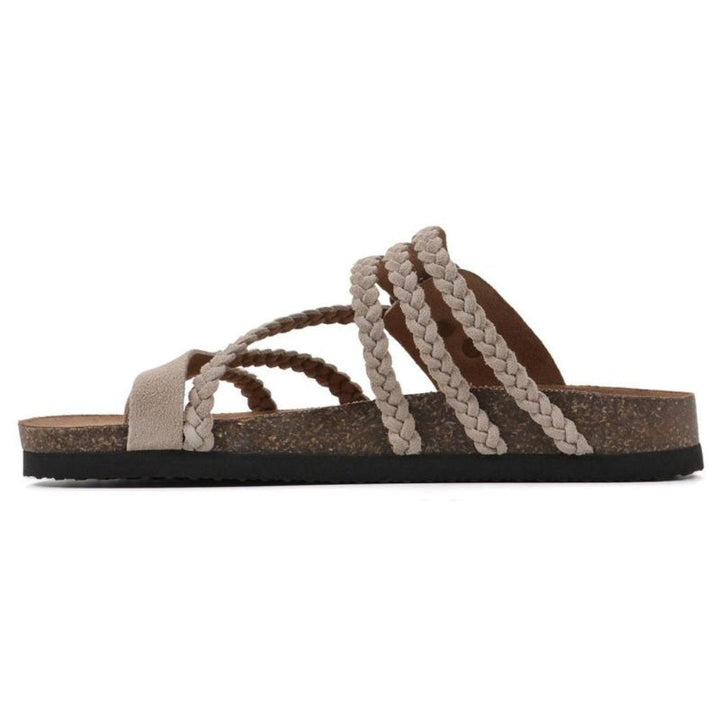 Comfortable women's braided flat sandals with an adjustable buckle, ideal for stylish summer outfits.