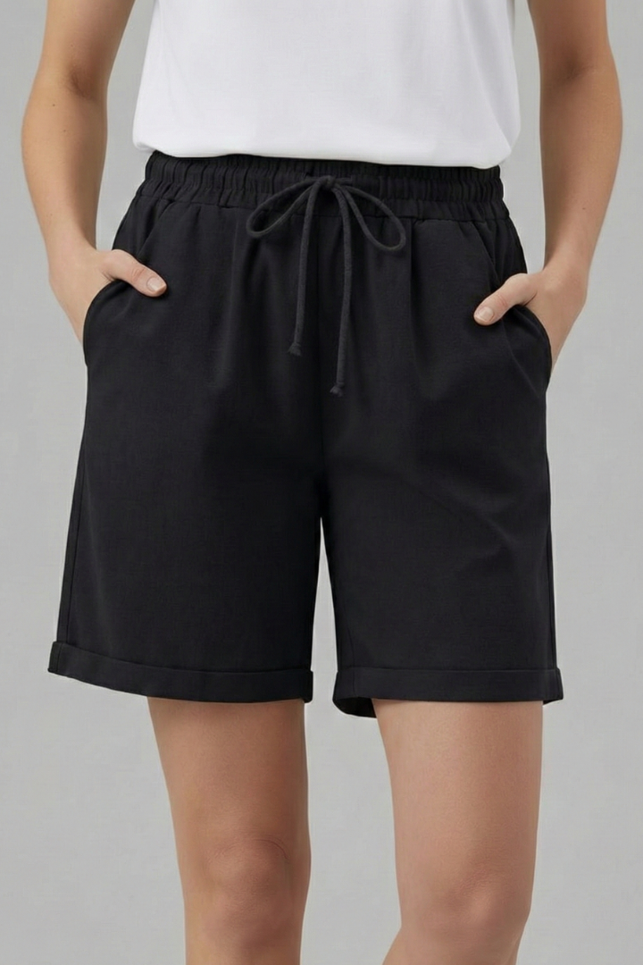 Folded women's casual shorts in soft fabric, drawstring waist, and deep functional pockets.
