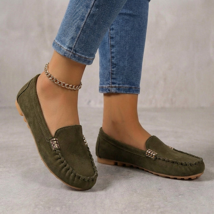Close-up of women's comfortable driving moccasins, highlighting orthopedic support & stylish metallic accent.