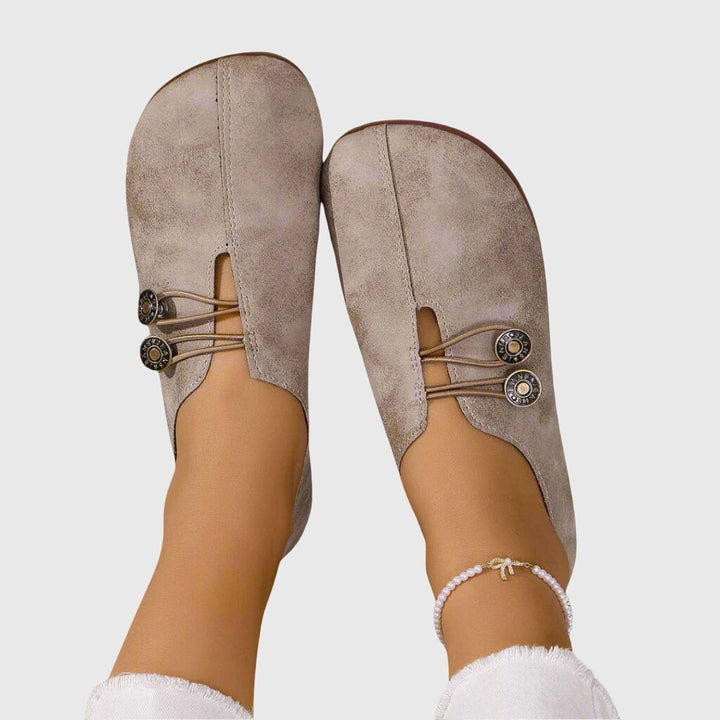 Stylish women's slip-on flat shoes with toggle lace, offering easy wear and flexible barefoot comfort.