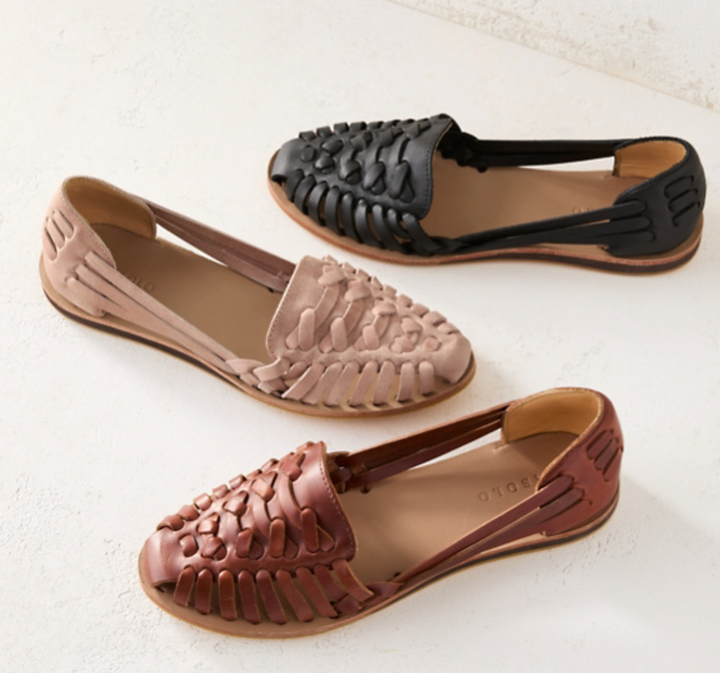 Close-up of stylish women's slip-on sandals, highlighting soft straps and cushioned footbed for comfort.